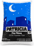 A large white plastic bag of Patricia Fine Pillows, 100% Polyester Fiber, featuring a blue and black graphic of a crescent moon over a city skyline.